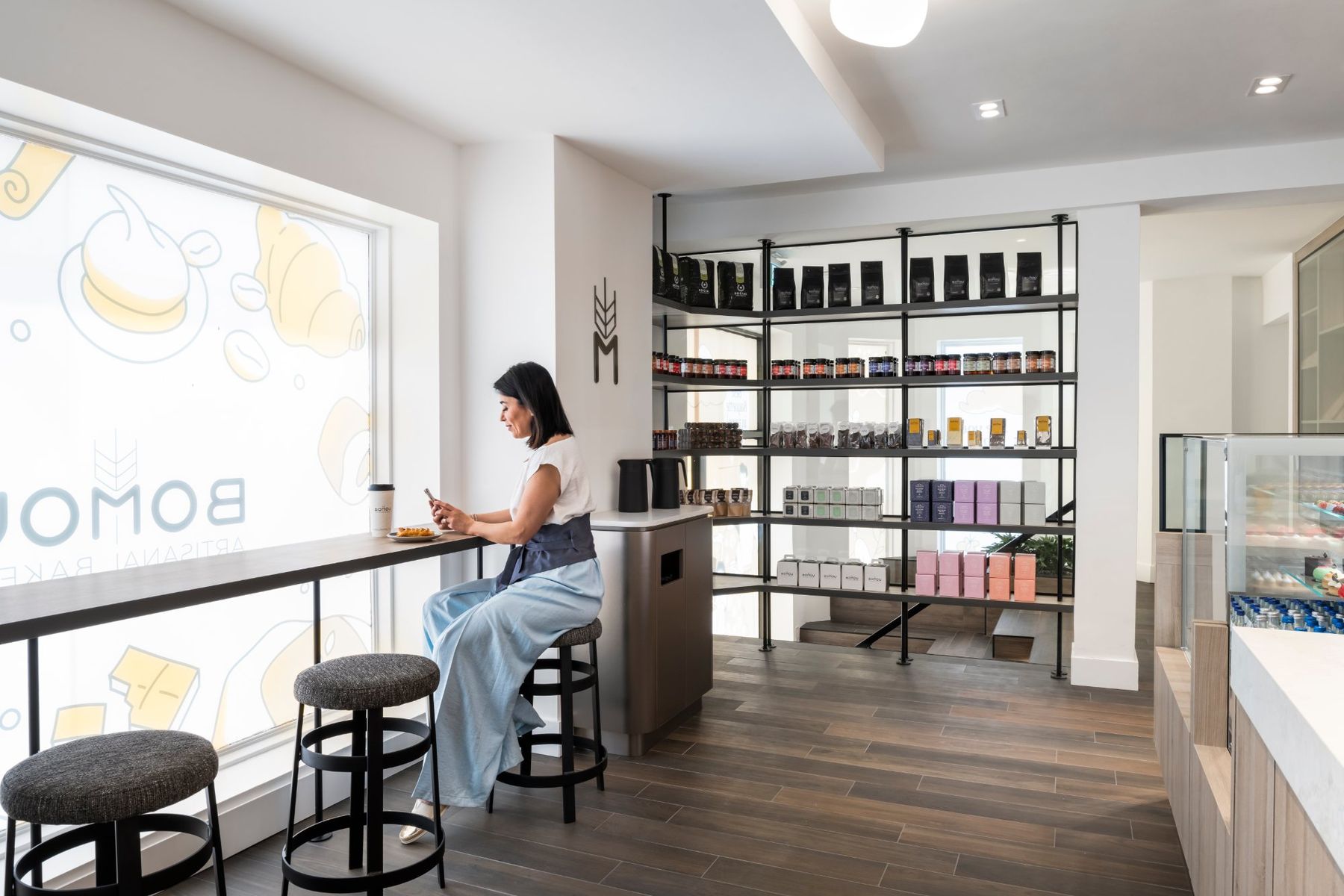 Bakery café with a long window counter and retail shelving