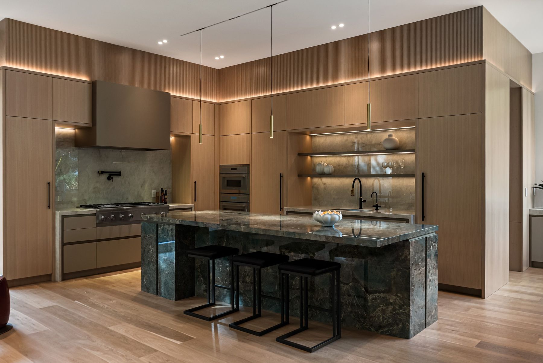 Kitchen and green stone island — The Offset, Toronto — interior design by RZ Interiors