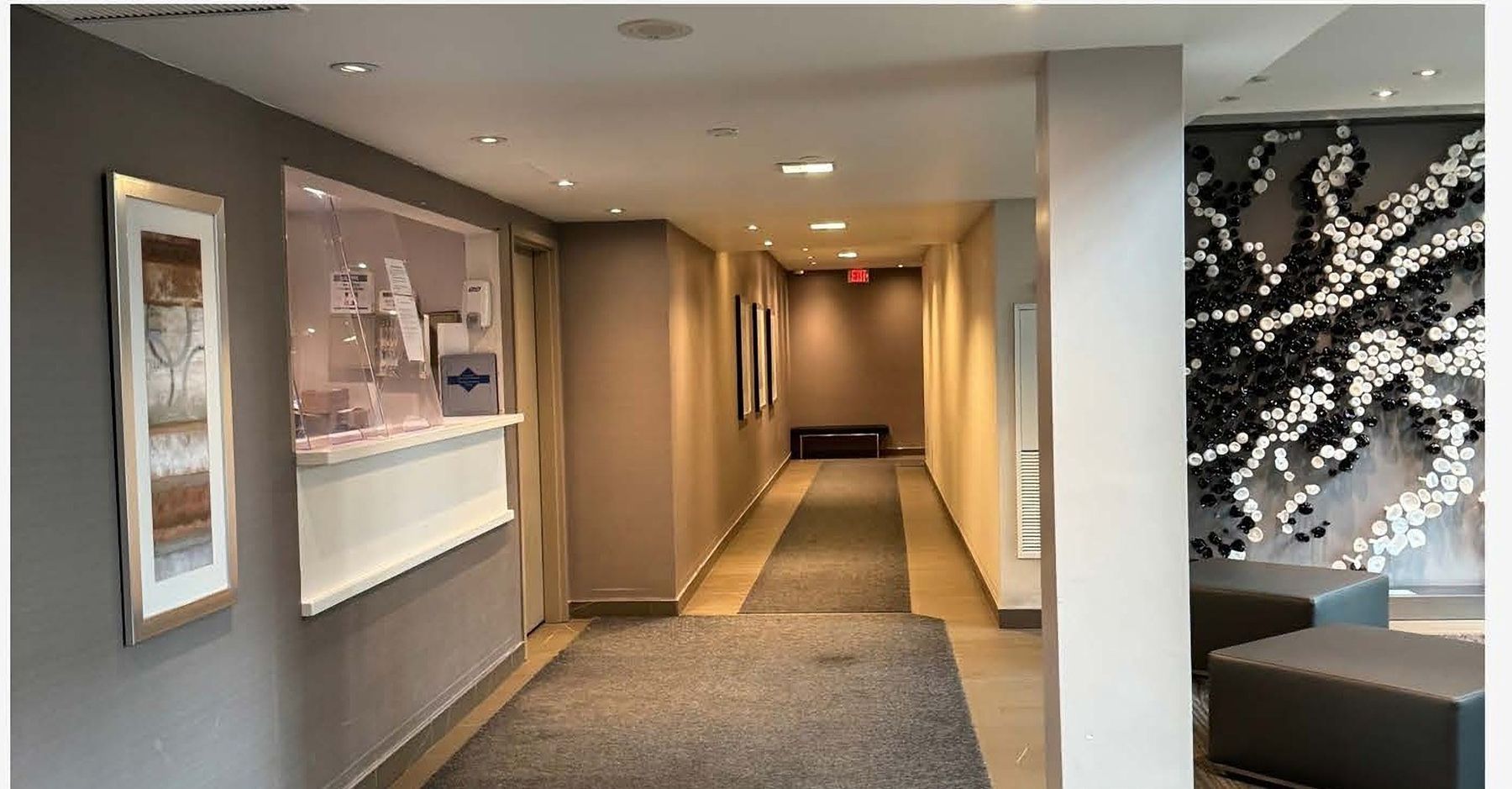 Lobby and concierge, before — The Courtyard Tower, Queen West, Toronto — interior design by RZ Interiors