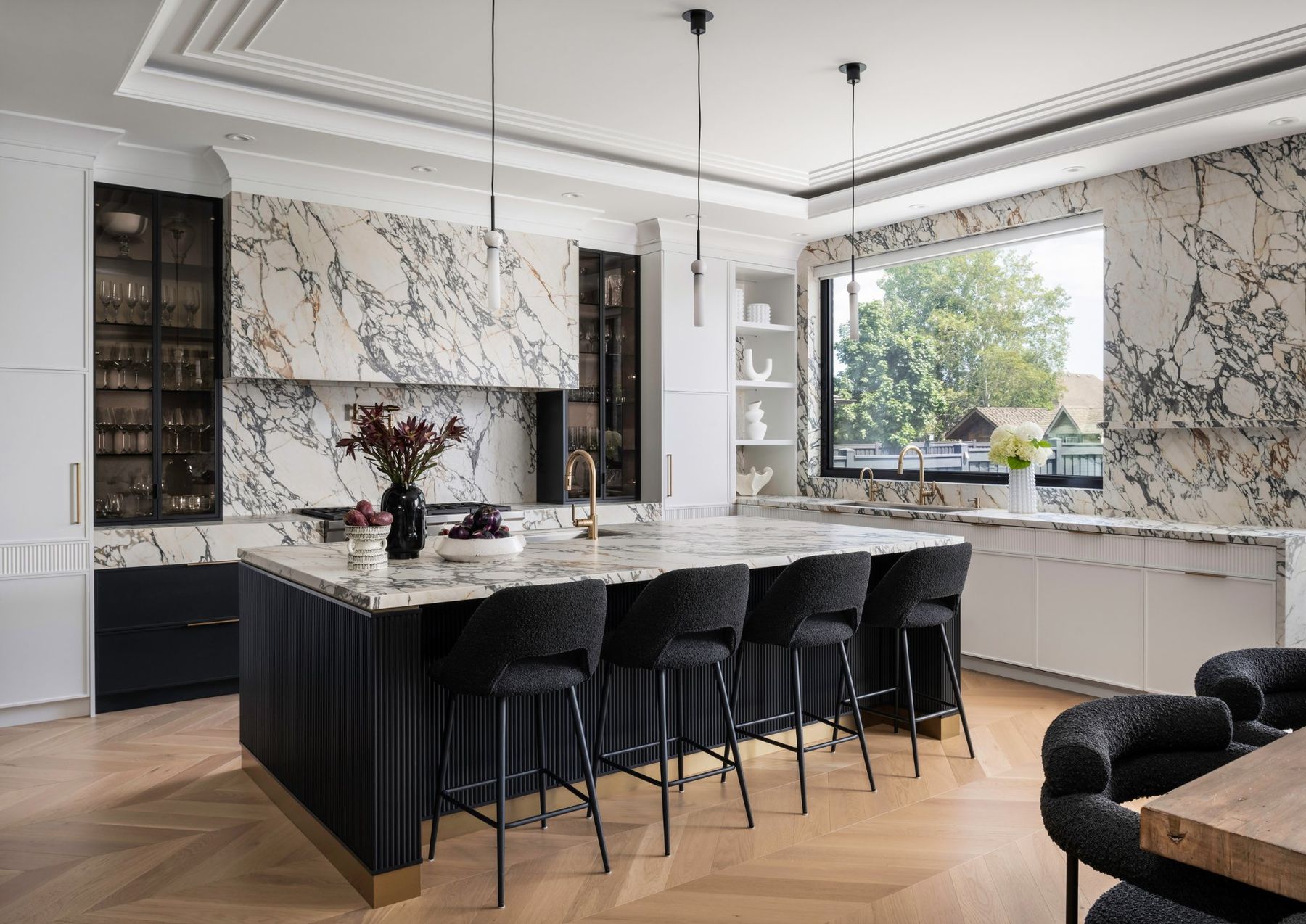 Monochrome kitchen with marble and black millwork by RZ Interiors