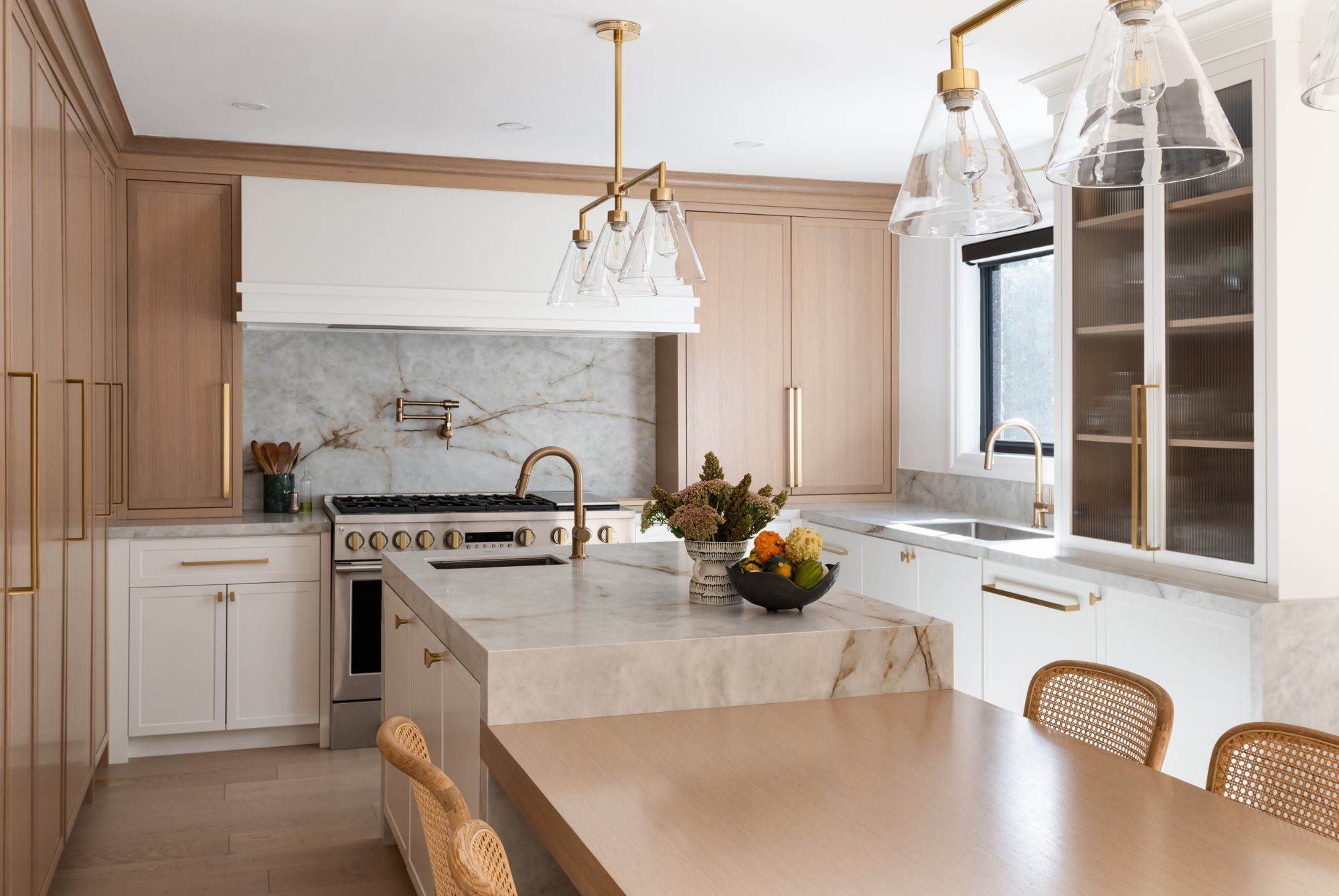 Kitchen with custom oak millwork and a stone island