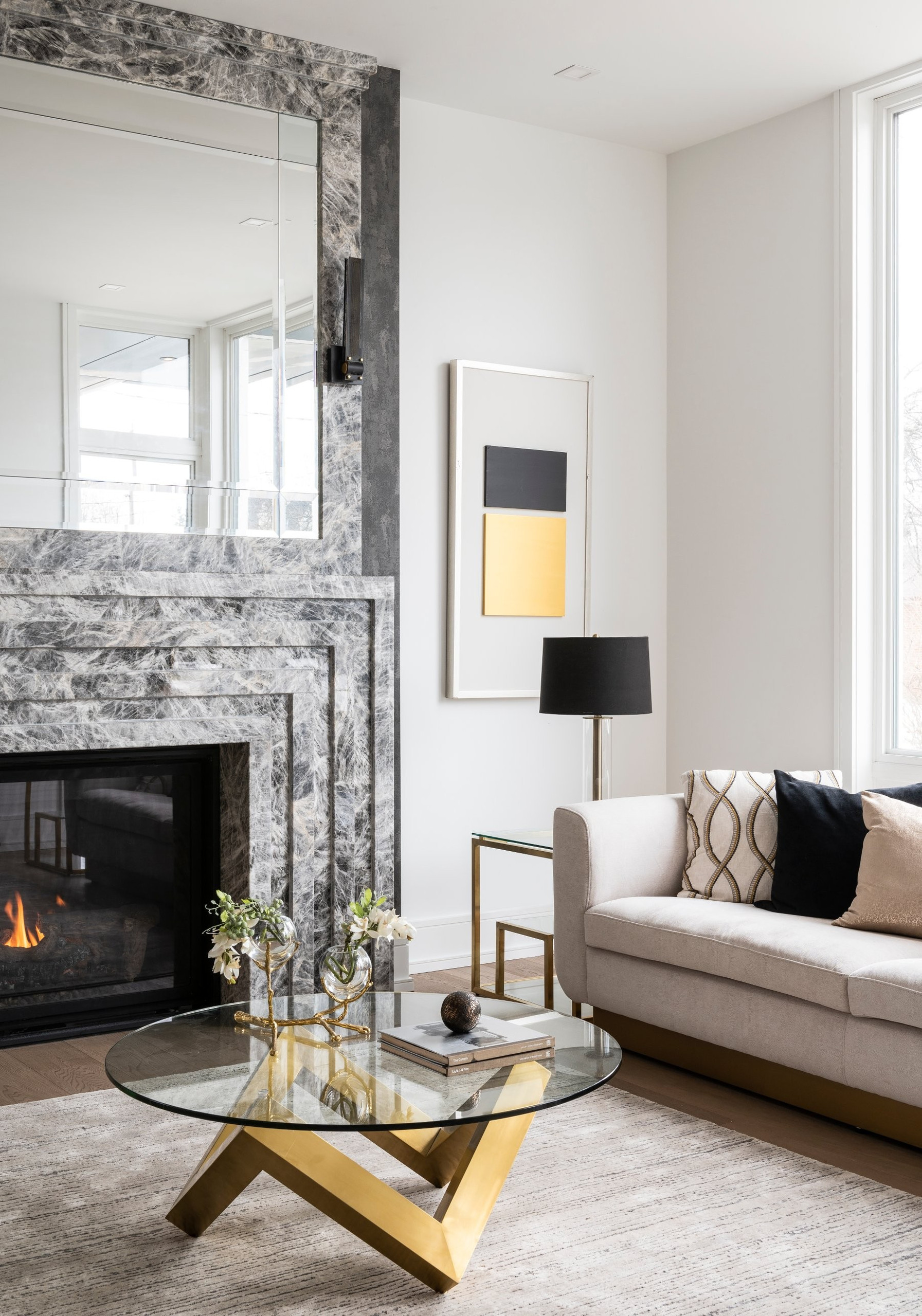 Stone fireplace and mirror — Two Volumes, North York, Toronto — interior design by RZ Interiors