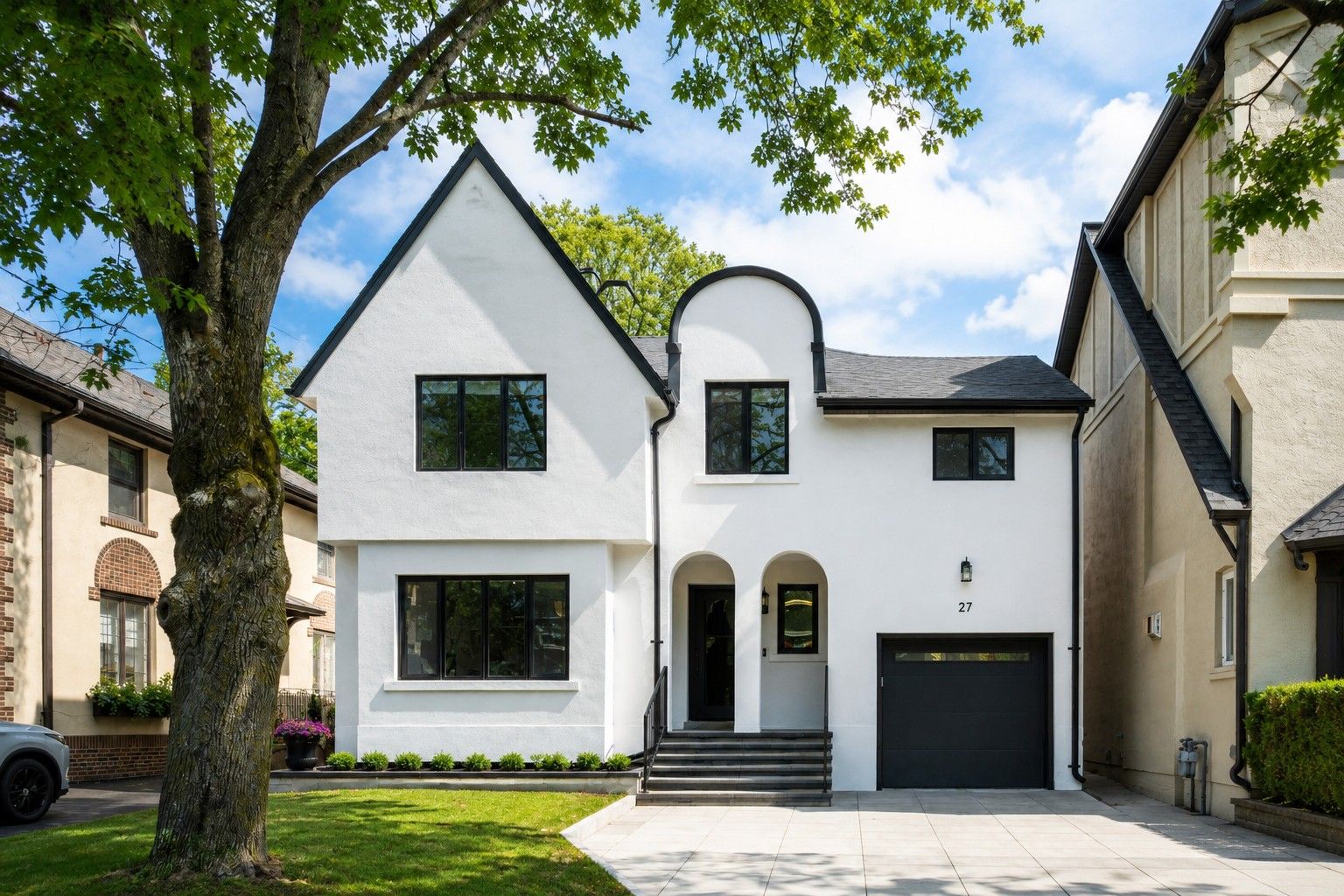 The Tudor façade and its double archways — The Open House, Moore Park, Toronto — interior design by RZ Interiors
